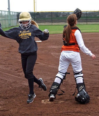Image: Britney Chambers crosses home plate for Italy’s JV girls.