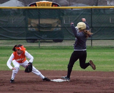 Image: Hannah Washington leaps onto second base to beat the tag.