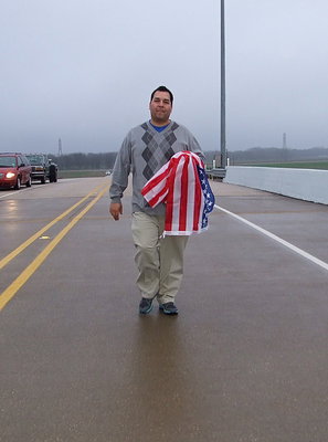Image: Monolithic Constructors, Inc. draftsman, Daniel Celis arrives with an American flag in hand to honor Chris Kyle.