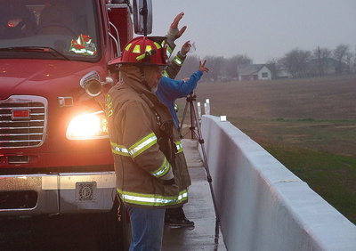 Image: Firefighters wave at passing motorists who honk in approval of the gathering in support for Chris Kyle.