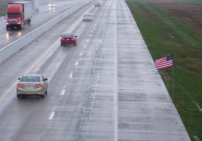 Image: A flag along Highway 35 waves for Chris Kyle and all American soldiers.