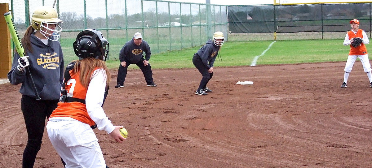 Image: JV Lady Gladiator Lillie Perry works the pitcher while teammate Hannah Washington looks for an opportunity to steal home.