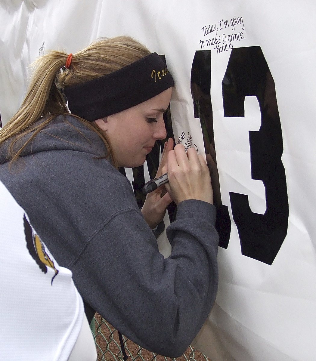 Image: Sophomore Lady Gladiator Madison Washington list her goal on a team banner before the varsity Lady Gladiators take on Avalon.