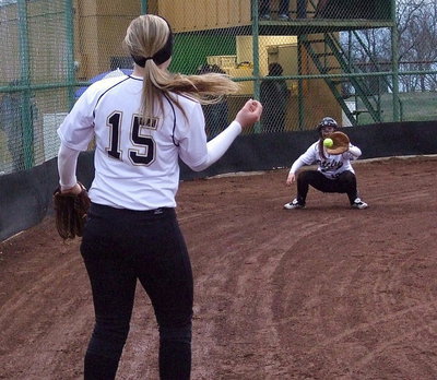 Image: Jaclynn Lewis(15) throws a strike to catcher Paige Westbrook before the game against Hubbard.