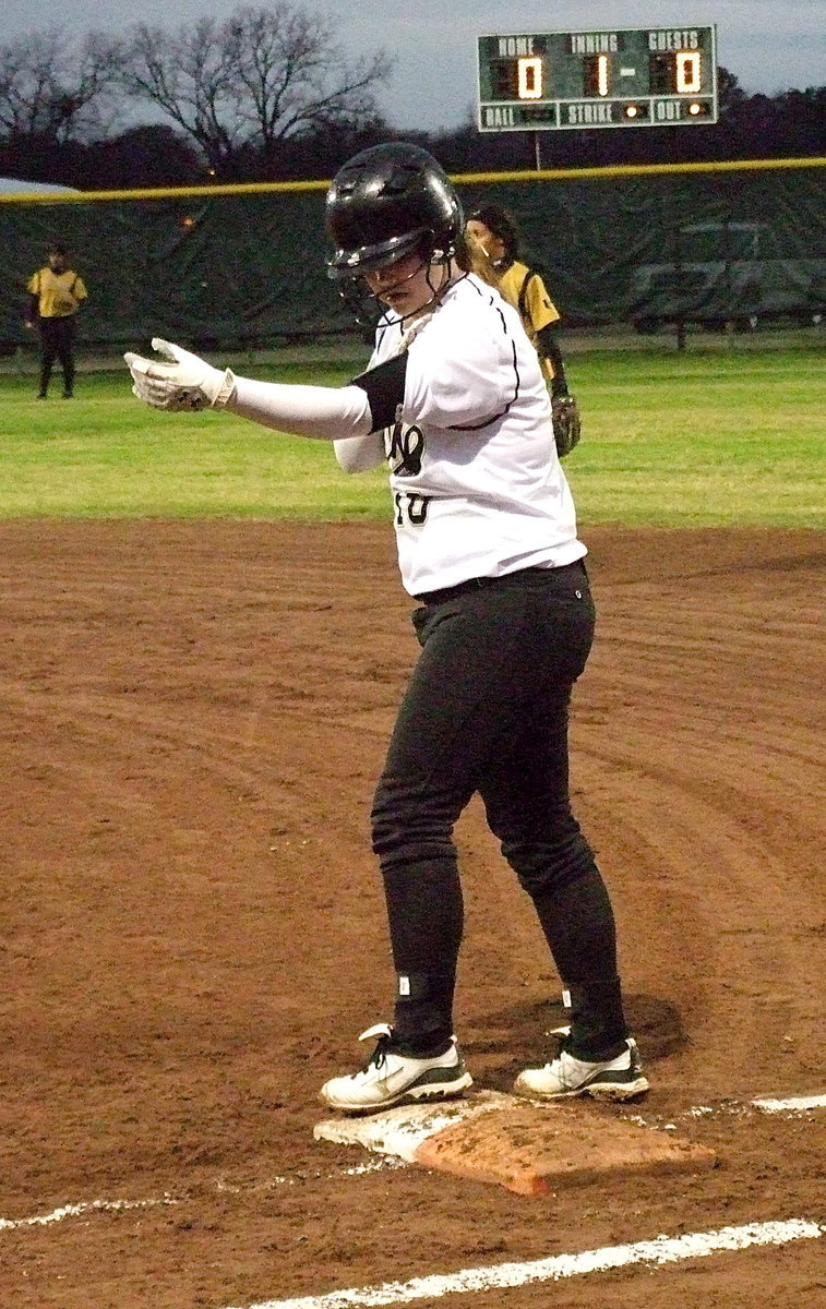 Image: Paige Westbrook checks the play call after reaching first-base.