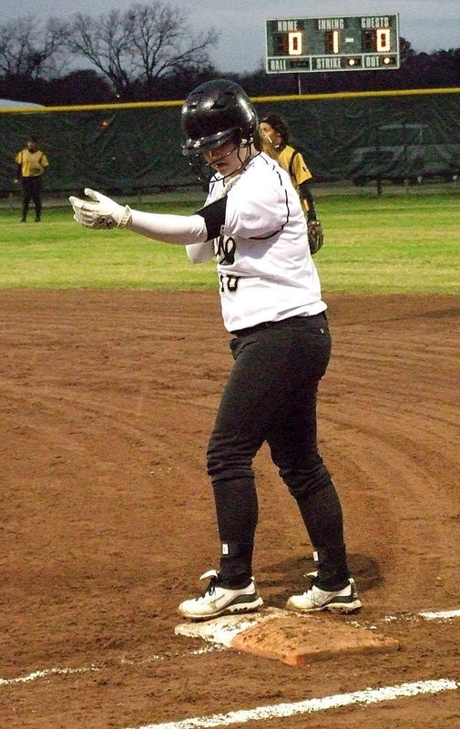 Image: Paige Westbrook checks the play call after reaching first-base.