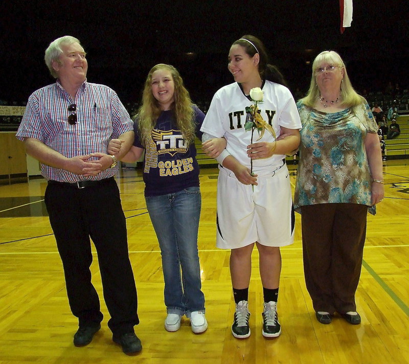 Image: Lady Gladiator senior Alyssa Richards is escorted by he little sister ChaCha Richards, and her grandparents Greg and Elaine Richards while celebrating Senior Night 2013 inside Italy Coliseum. Alyssa won her final home game wearing the old gold and white with Italy defeating the Itasca Lady Wampus Cats.