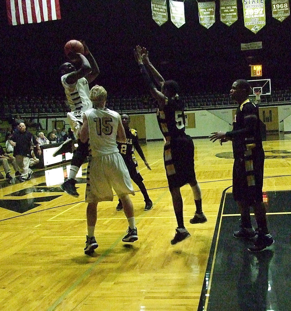 Image: Marvin Cox(3) uses Gladiator teammate Cody Boyd(15) as a shield to drop in two of his 9-points during Italy’s senior night against Itasca.