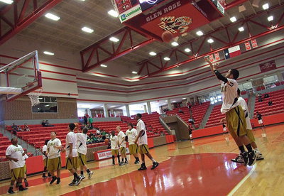 Image: Senior Caden Jacinto tries a 3-point shot from the left corner during the pre-game warmups.