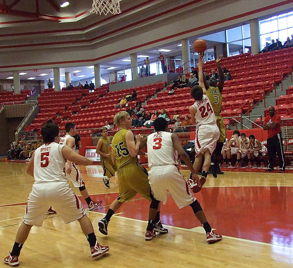 Image: Gladiator Marvin Cox(3) spots up and shoots over an Olney defender as teammate Cody Boyd(15) battles on the block.