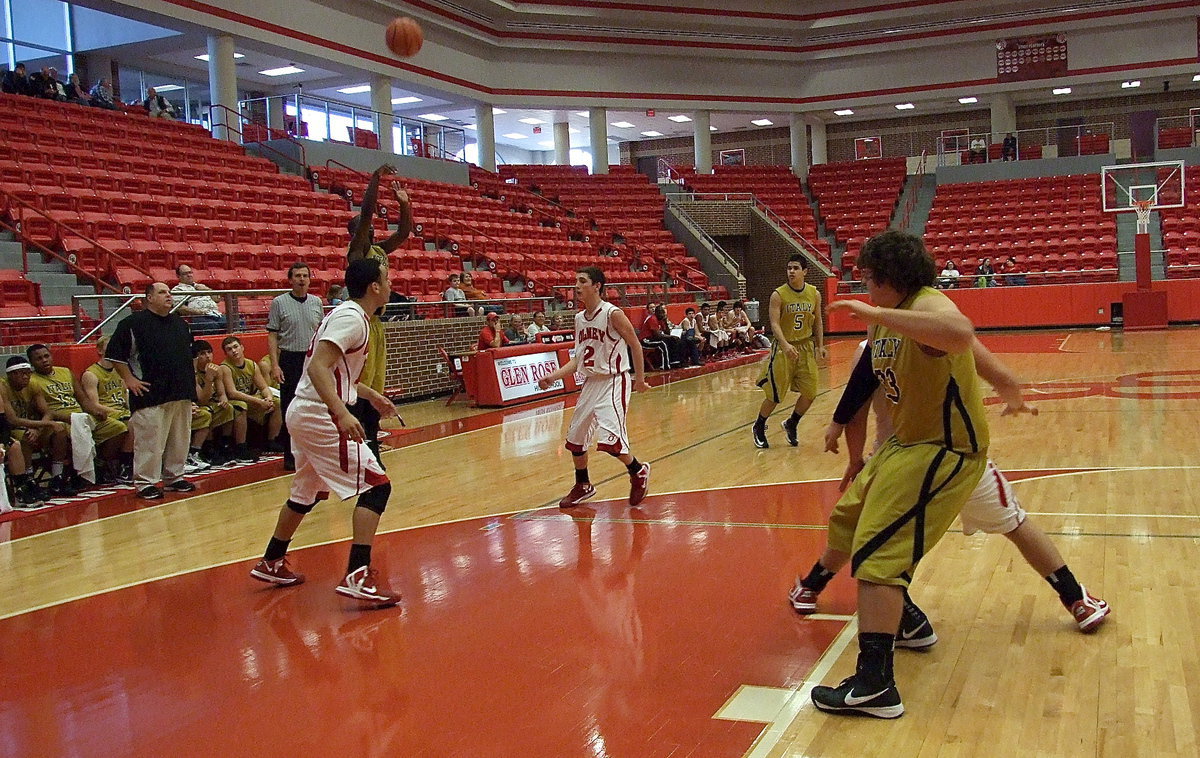 Image: Taking the shot is Marvin Cox(3) while Kevin Roldan(33) fights his way underneath for rebounding position.