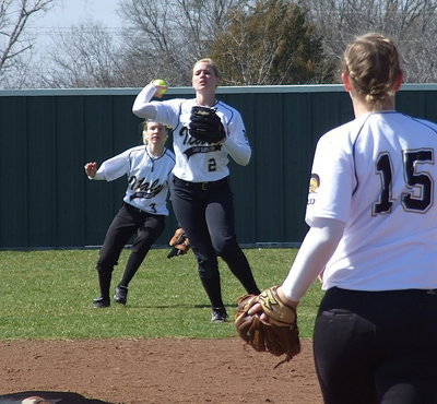 Image: With Jaclynn Lewis watching from the circle, Madison Washington(2) catches a pop fly for an out in the right field gap as senior right fielder Brooke Miller(3) backs her up.