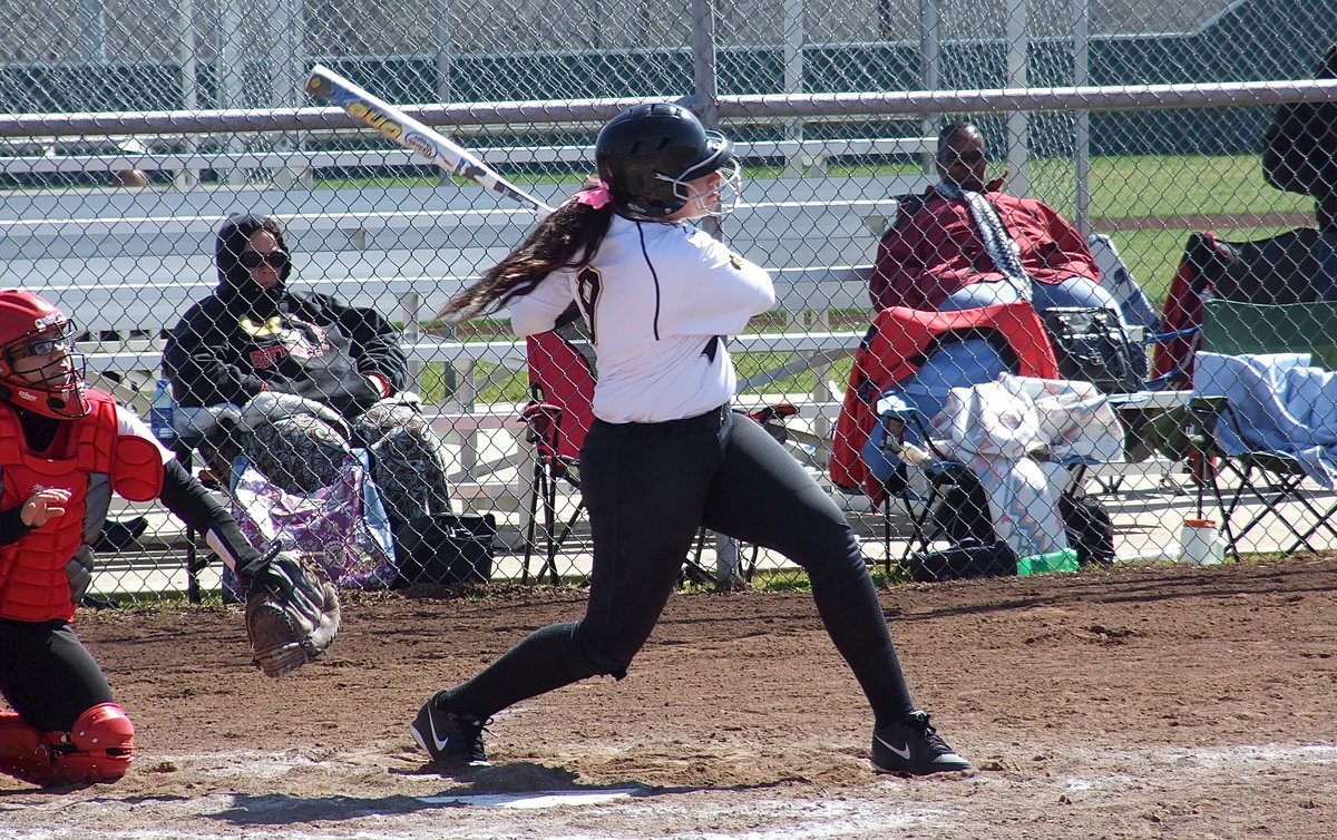 Image: It’s Gone! Senior power-hitter Alyssa Richards(9) has only just returned to the batter’s box after battling under the basket for the Lady Gladiators who reached the basketball playoffs this season. In just her sixth game back, Richards goes yard sending her first homerun of 2013 over the left field fence against Terrell.