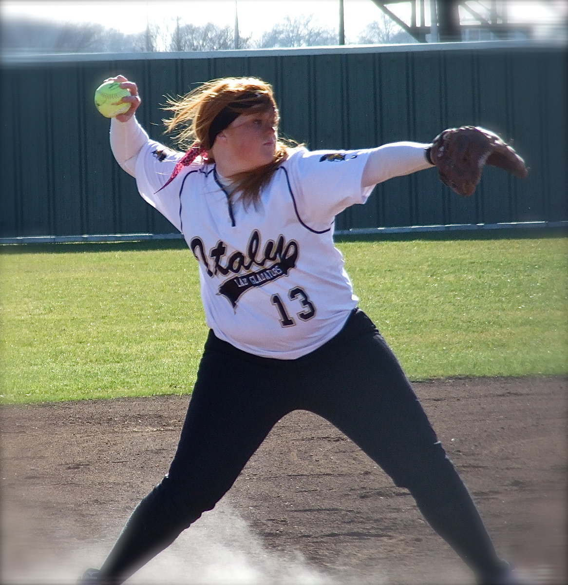 Image: From a cloud of dust and fiery vale emerges Lady Gladiator third baseman Katie Byers(13) who quickly covers a Scurry bunt.