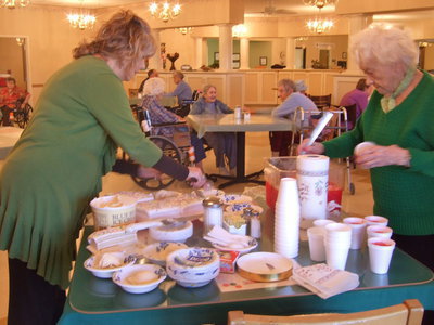 Image: Celeste Carroll (activities director) and one of the volunteer residents getting everything ready to celebrate.