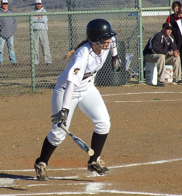 Image: Jaclynn Lewis(15) hits and then hurries to first-base.