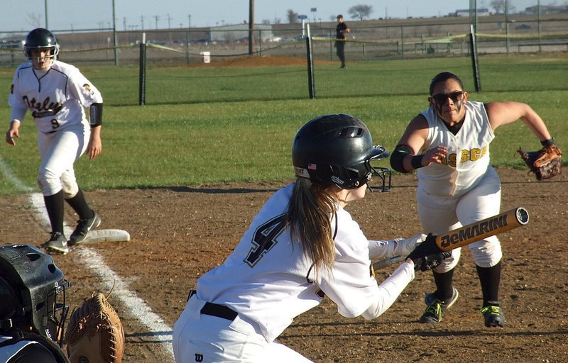 Image: Kelsy Nelson(4) is proving to be a consistent offensive weapon for the Lady Gladiators as she attempts to score teammate Alyssa Richards(9) from third-base to help Italy secure a district opening win, 13-4 over Itasca.