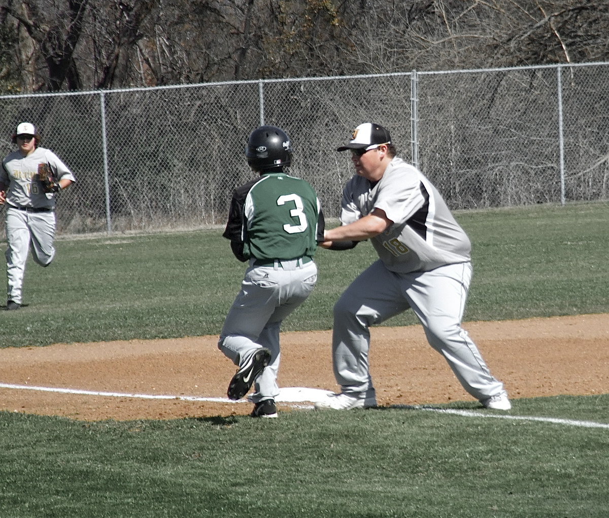 Image: Making the tag is Italy’s third baseman John Byers(18) who catches a Bobcat from Kerens as Kevin Roldan(16) hustles in to back the play up from left field.