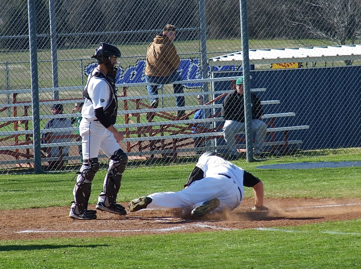 Image: Italy’s Kevin Roldan(16) slides into home base for an Italy run.