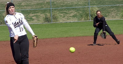 Image: Jaclynn Lewis pitches while second baseman Bailey Eubank has her back.