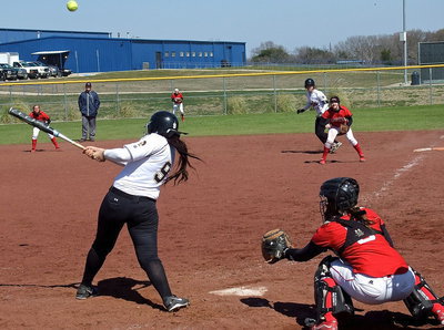 Image: With Jaclynn Lewis(15) on base, Alyssa Richards(9) sends a shot into the outfield against Lorena.
