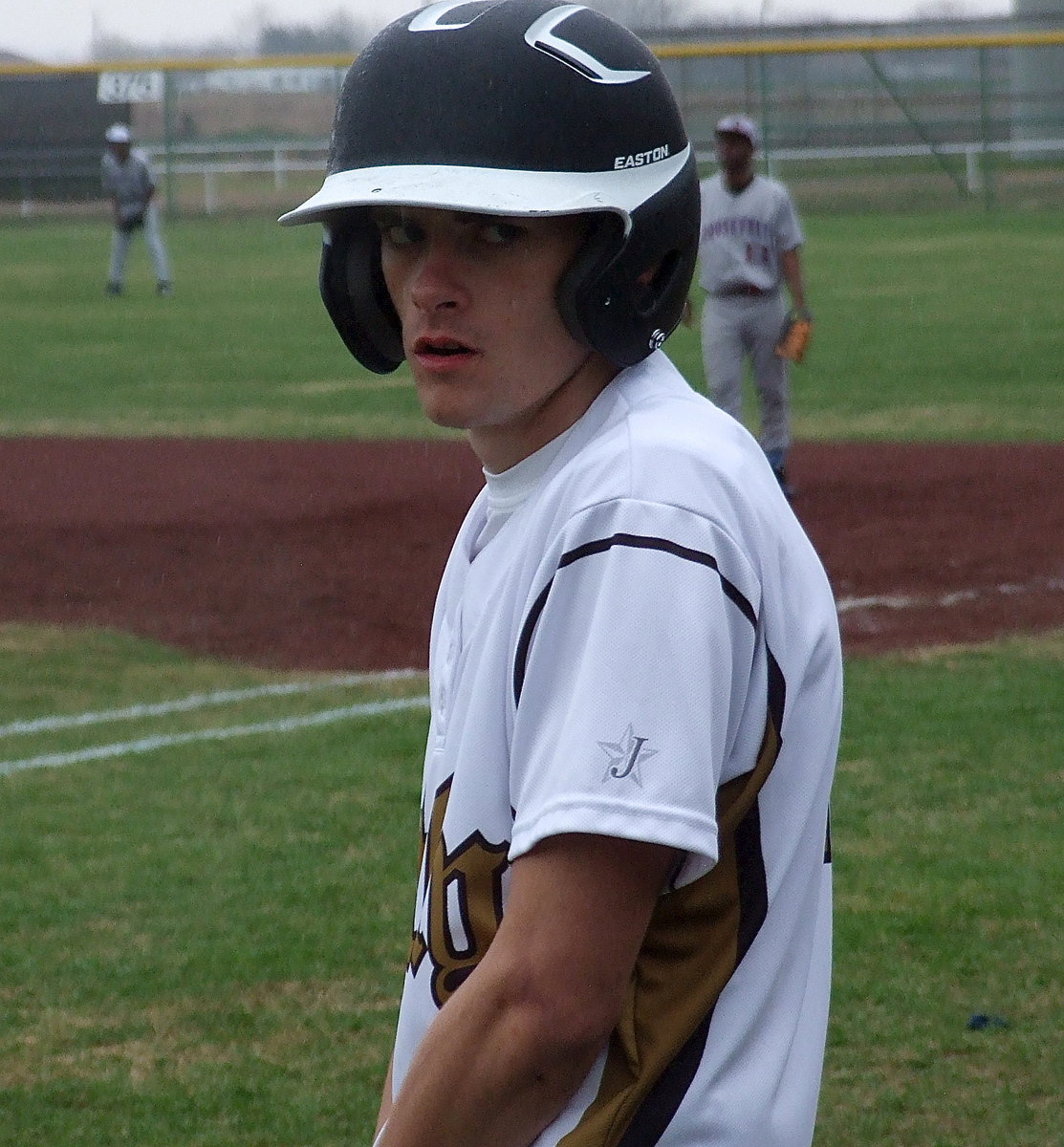 Image: It pours on Roosevelt as Justin Wood(4) prepares to bat in the rain.