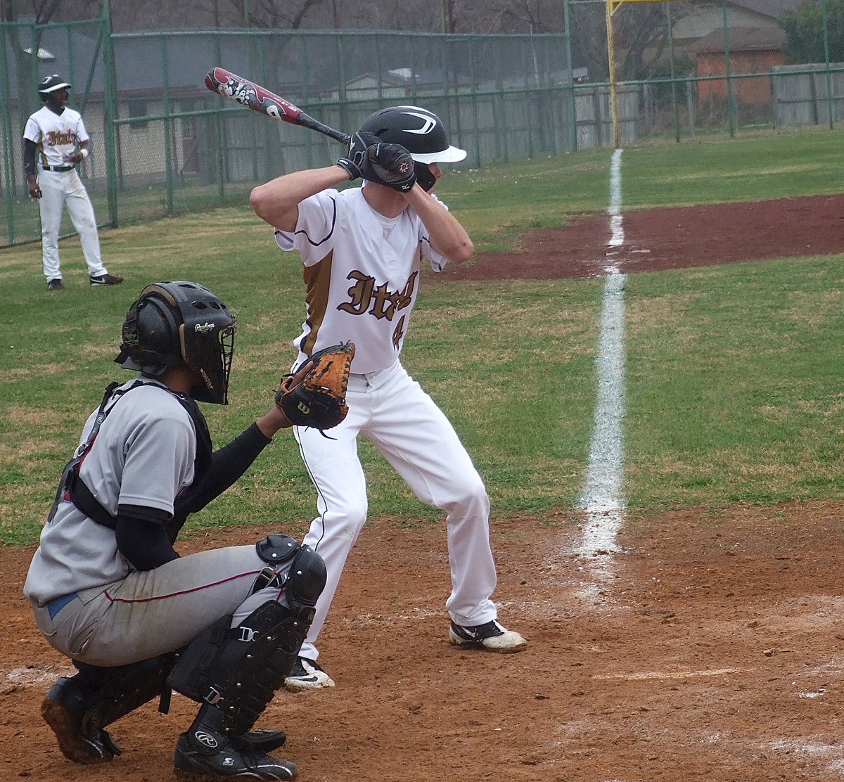 Image: Justin Wood(4) attempts to score Marvin Cox(3) from third-base.