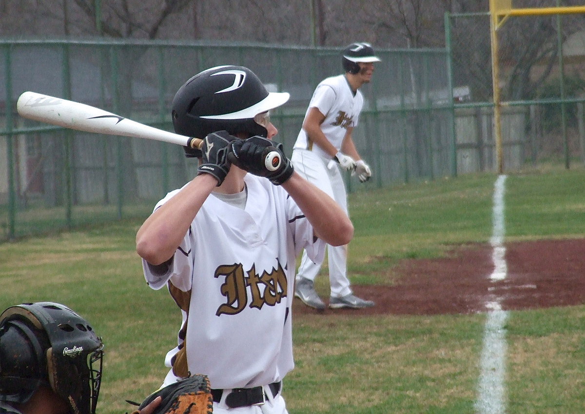 Image: Ryan Connor tries his luck at the plate with teammate Cole Hopkins(9) hoping to score from third.