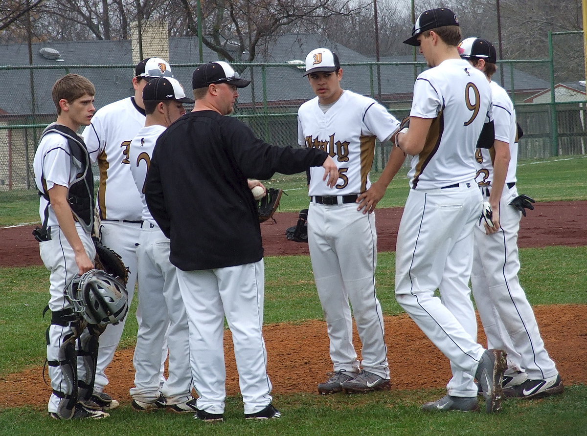 Image: Head coach Josh Ward talks with his players during a field timeout.