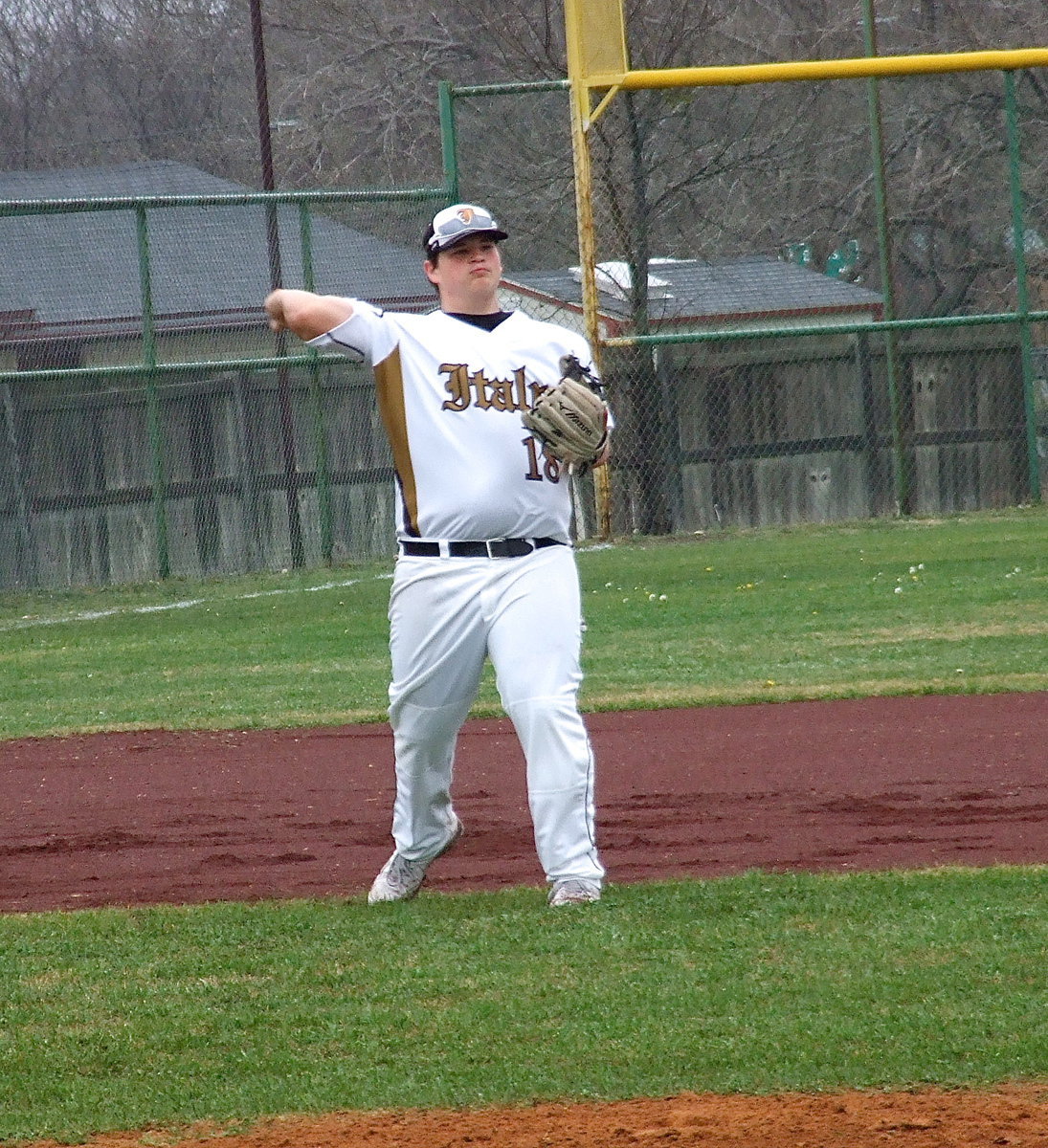 Image: Third-baseman John Byers(18) keeps the cannon warm between frames.