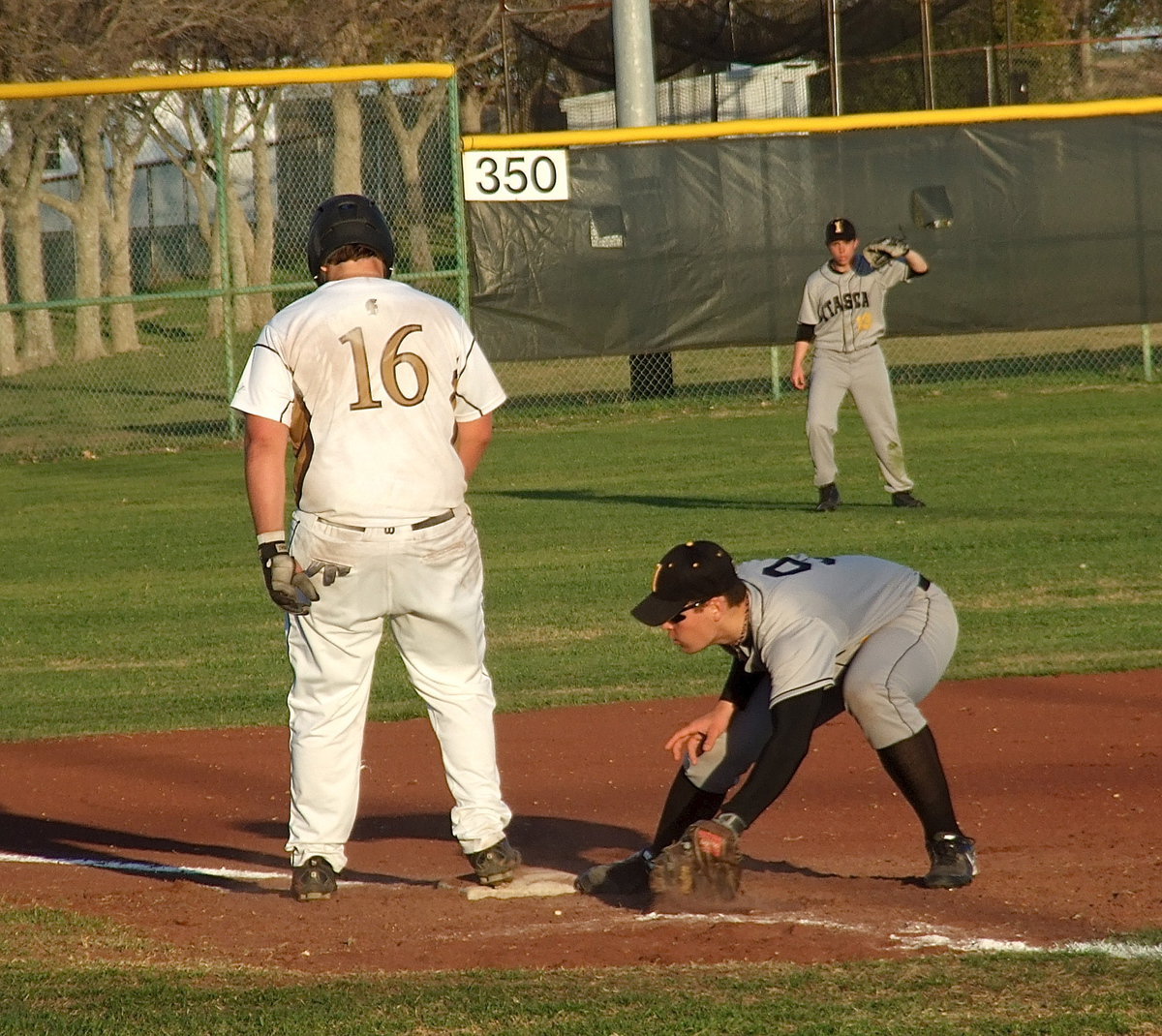 Image: Itasca keeps Kevin Roldan(16), the speedster, glued to third-base.