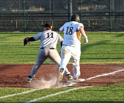 Image: Gladiator John Byers(18) reaches first-base in time to beat the throw for single.