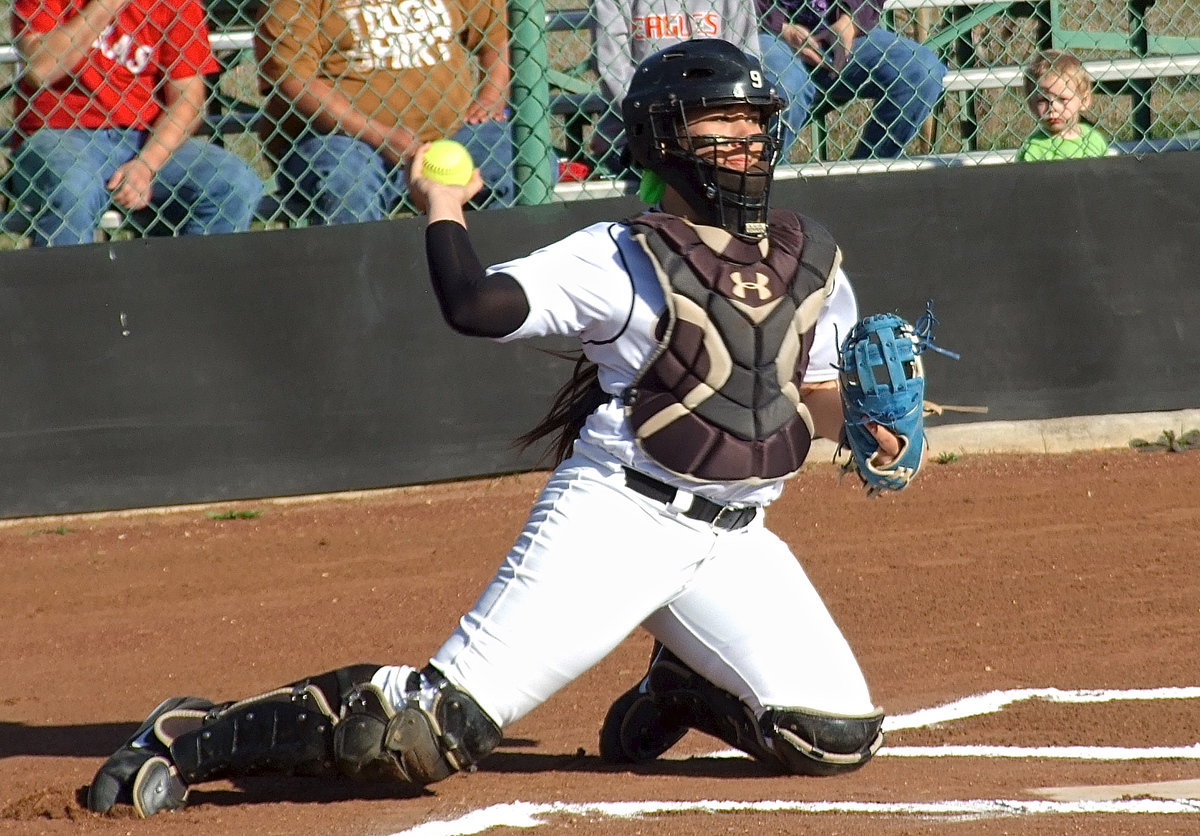 Image: Catcher Alyssa Richards(9) throws down to second base from her knees and puts the ball on the money to teammate Madison Washington.