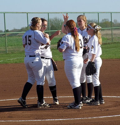 Image: After a strikeout, Lady Gladiator pitcher, Jaclynn Lewis(15), meets with her infielders, third baseman Paige Wesbrook(10), first baseman Katie Byers(13), shortstop Madison Washington(2) and second baseman Britney Chambers(4).