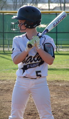 Image: Tara Wallis(5) times her swing while waiting to bat.