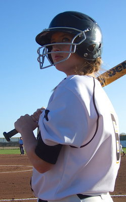 Image: Hannah Washington(6) peers at the fans before taking her turn at bat.