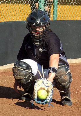 Image: Catcher Alyssa Richards(9) warms up her pitcher.