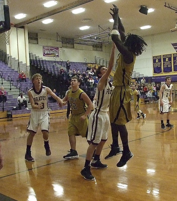 Image: Ryheem Walker(10) takes a baseline jumper with Zain Byers(22) going in for the rebound.