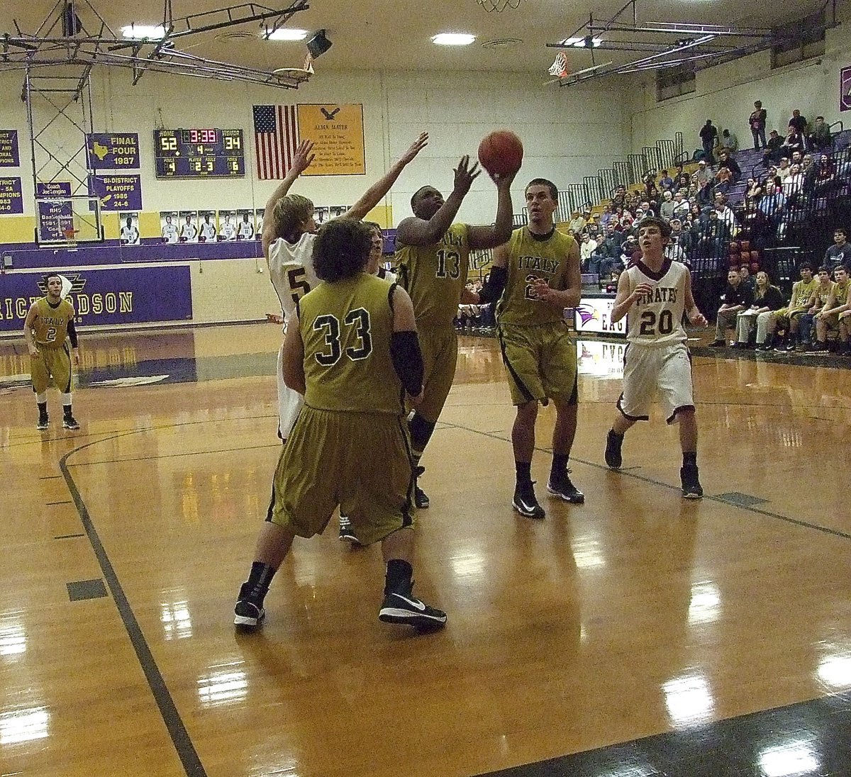 Image: Darol Mayberry(13) maneuvers inside for a score with Kevin Roldan(33) and Cole Hopkins(21) in position to rebound.