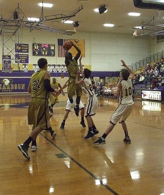 Image: Marvin Cox(3) rises in traffic with Cole Hopkins(21) ready to rebound. Unfortunately, Italy’s 2013 state champion basketball goal ended at Richardson High School with Collinsville getting the bi-district win.