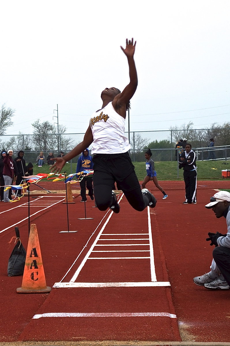 Image: Italy’s Kortnei Johnson reaches for the gold in the long jump.