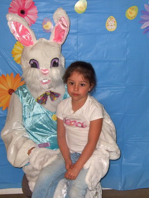 Image: Caty Betancourt (5 yrs old) sitting on the Easter Bunny’s lap.