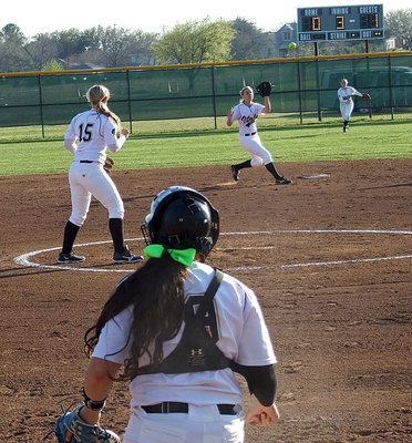 Image: Pitcher Jaclynn Lewis(15) looks on and centerfielder Kelsey Nelson provides backup as catcher Alyssa Richards(9) throws down to shortstop Madison Washington(2) who manages to tag out an approaching Itasca runner caught trying to steal second base.