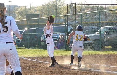 Image: Covering a bunt, pitcher Jaclynn Lewis(15) throws to second baseman Bailey Eubank(1) who covers first base to catch the out.