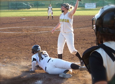 Image: After a low pitch escapes the catcher, Jaclynn Lewis(15) slides home to pull Italy within one point of Itasca, 5-4, but the play is not over…