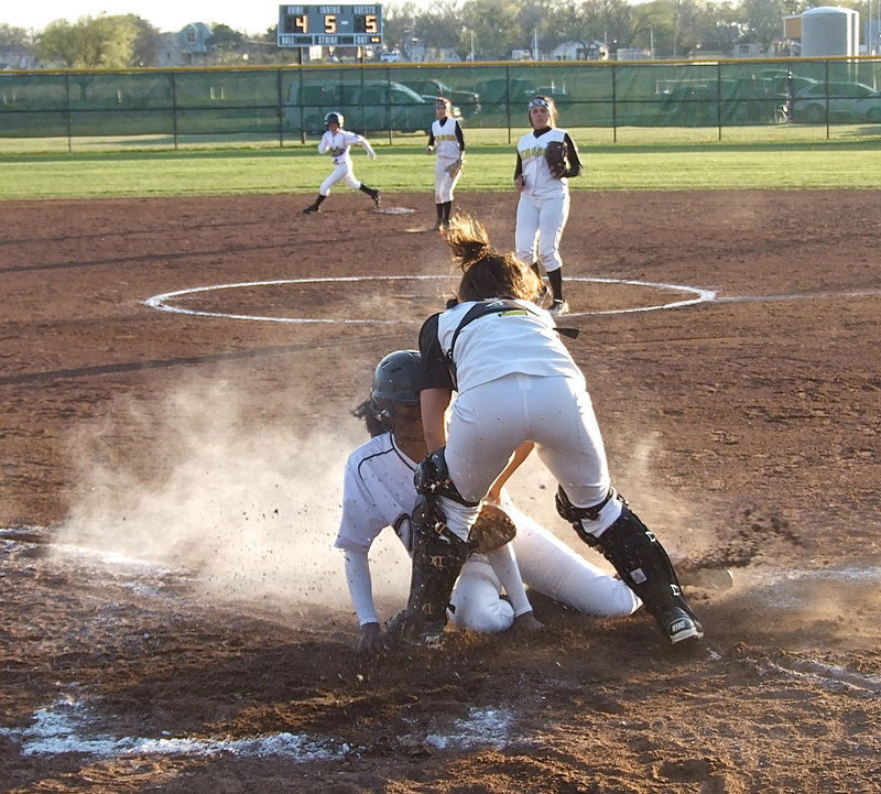 Image: …as the play continues, K’Breona Davis tries to sneak across home plate to tie the game but Itasca recovers in time to get the third out and preserve their dwindling lead, 5-4.