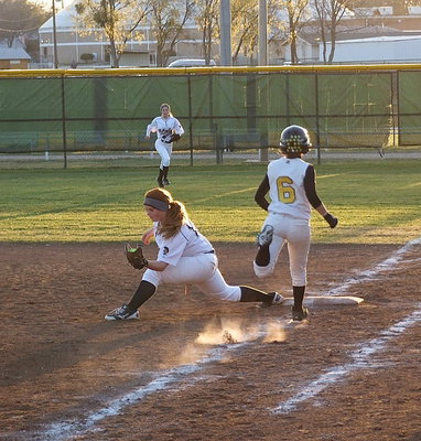 Image: First baseman Katie Byers(13) stretches to make the catch and get a much needed out for Italy with right fielder Britney Chambers hurrying to backup Byers.