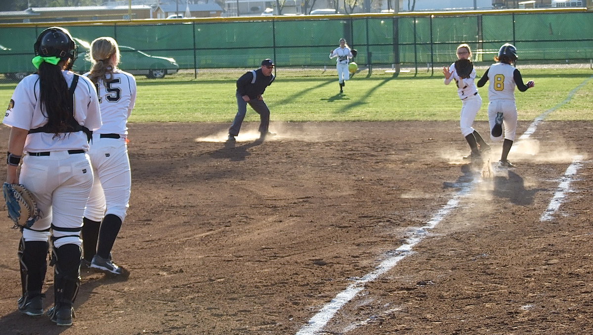 Image: After a bunt, second baseman Bailey Eubank(1) covers first base but Itasca beats the throw to safely reach the base.