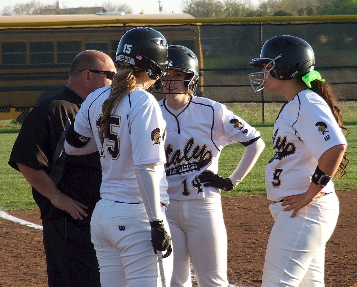 Image: Head coach Wayne Rowe organizes his offensive attack with Jaclynn Lewis(15), Kelsey Nelson(14) and Alyssa Richards(9).