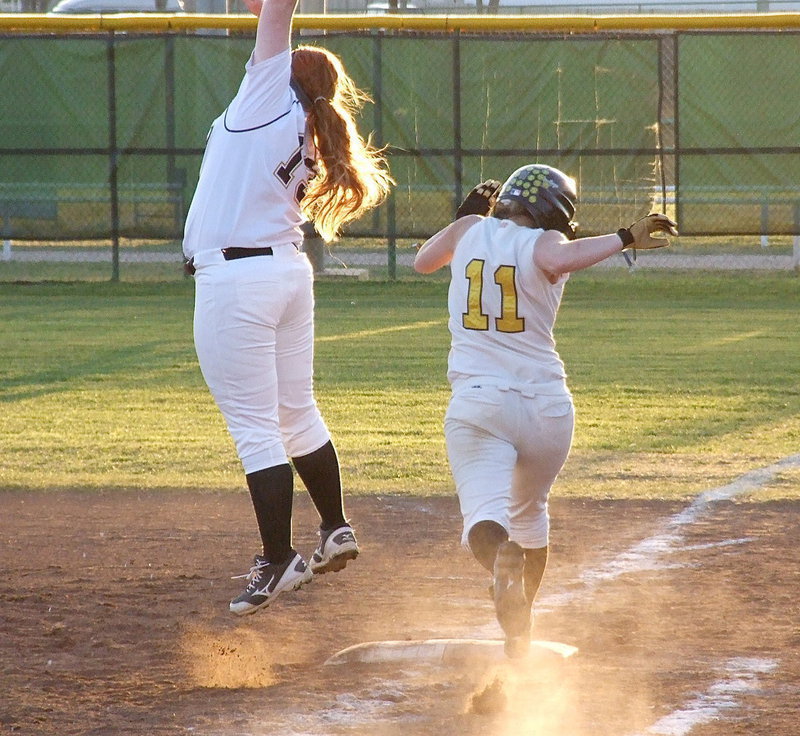 Image: Both teams gave it their all as Italy’s Katie Byers(13) leaps for an overthrow at first base while an Itasca runner sprints to the bag.